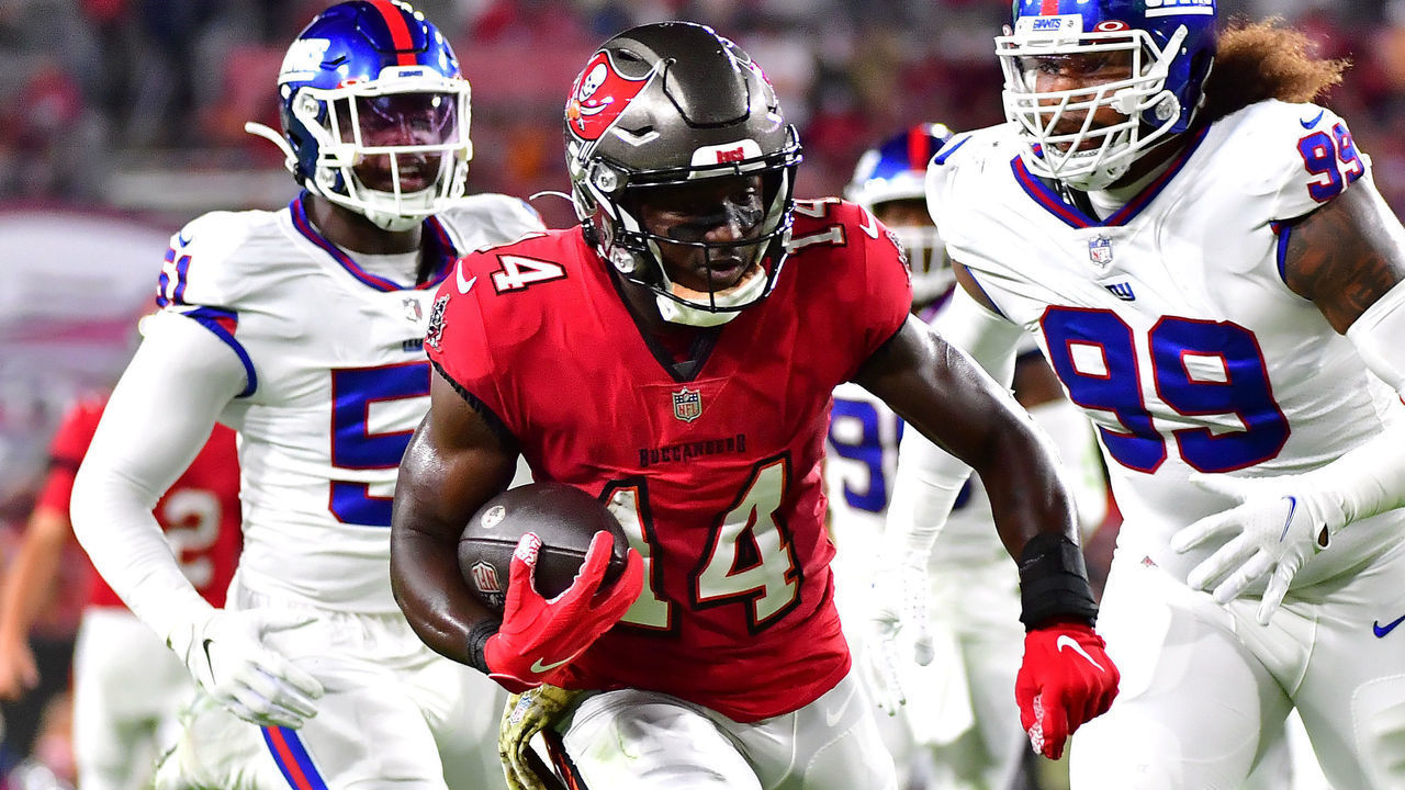 TAMPA, FLORIDA - NOVEMBER 22: Chris Godwin #14 of the Tampa Bay Buccaneers carries the ball down the field for a touchdown as Leonard Williams #99 and Azeez Ojulari #51 of the New York Giants defend in the first quarter in the game at Raymond James Stadium on November 22, 2021 in Tampa, Florida.