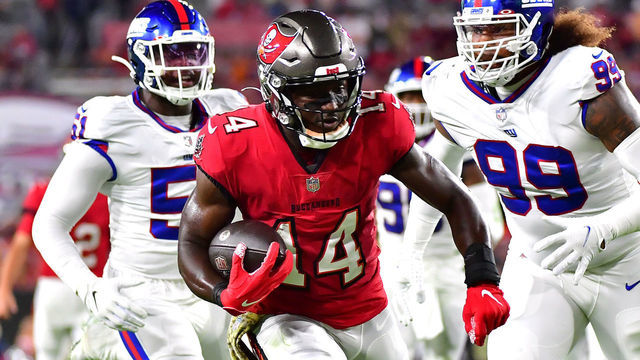 TAMPA, FLORIDA - NOVEMBER 22: Chris Godwin #14 of the Tampa Bay Buccaneers carries the ball down the field for a touchdown as Leonard Williams #99 and Azeez Ojulari #51 of the New York Giants defend in the first quarter in the game at Raymond James Stadium on November 22, 2021 in Tampa, Florida.
