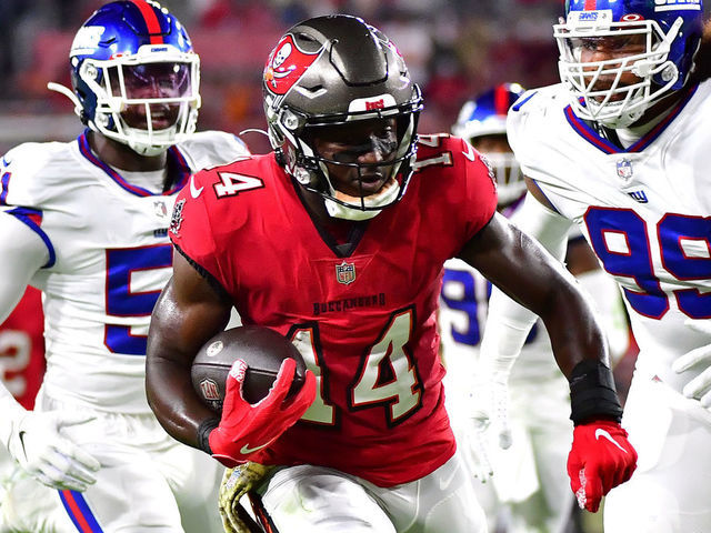 TAMPA, FLORIDA - NOVEMBER 22: Chris Godwin #14 of the Tampa Bay Buccaneers carries the ball down the field for a touchdown as Leonard Williams #99 and Azeez Ojulari #51 of the New York Giants defend in the first quarter in the game at Raymond James Stadium on November 22, 2021 in Tampa, Florida.