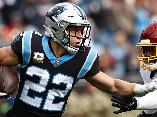 CHARLOTTE, NORTH CAROLINA - NOVEMBER 21: Christian McCaffrey #22 of the Carolina Panthers carries the ball against the defense of the Washington Football Team in the first quarter of the game at Bank of America Stadium on November 21, 2021 in Charlotte, North Carolina.