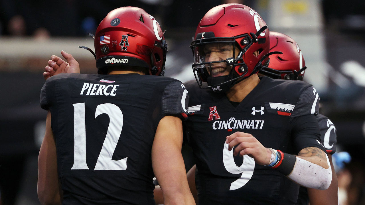 CINCINNATI, OHIO - NOVEMBER 20: Alec Pierce #12 and Desmond Ridder #9 of the Cincinnati Bearcats celebrate after scoring a touchdown in the second quarter against the SMU Mustangs at Nippert Stadium on November 20, 2021 in Cincinnati, Ohio.