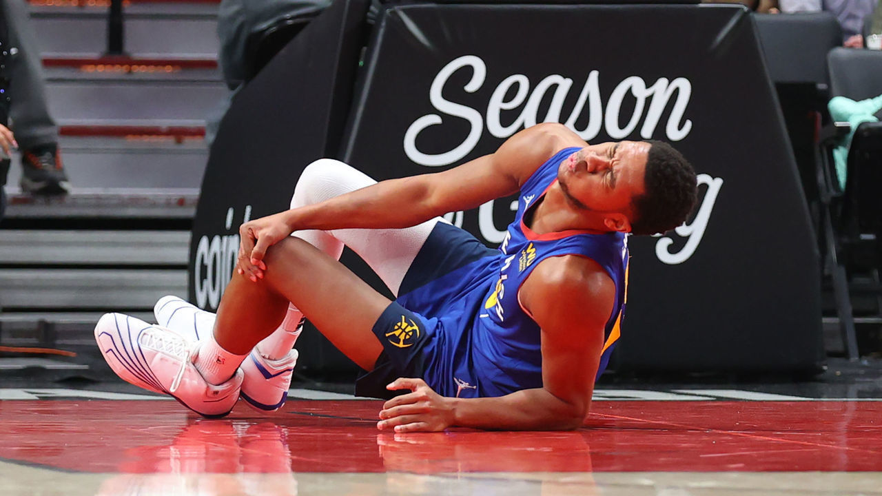 PORTLAND, OREGON - NOVEMBER 23: P.J. Dozier #35 of the Denver Nuggets reacts after sustaining an injury during the first half against the Portland Trail Blazers at Moda Center on November 23, 2021 in Portland, Oregon.