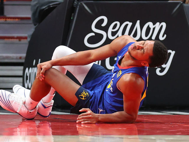 PORTLAND, OREGON - NOVEMBER 23: P.J. Dozier #35 of the Denver Nuggets reacts after sustaining an injury during the first half against the Portland Trail Blazers at Moda Center on November 23, 2021 in Portland, Oregon.