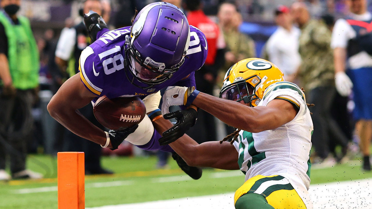 MINNEAPOLIS, MINNESOTA - NOVEMBER 21: Justin Jefferson #18 of the Minnesota Vikings dives into the end zone for a touchdown as Eric Stokes #21 of the Green Bay Packers tries to tackle in the fourth quarter at U.S. Bank Stadium on November 21, 2021 in Minneapolis, Minnesota.