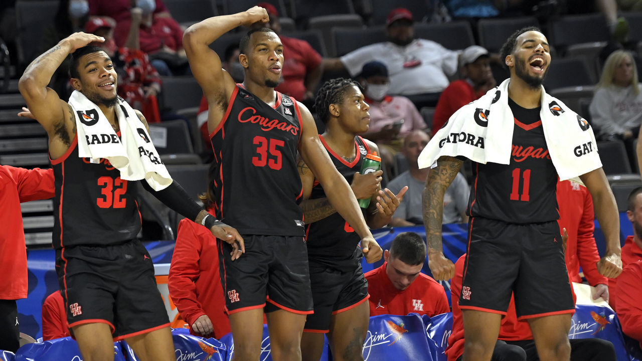 LAS VEGAS, NEVADA - NOVEMBER 24: Reggie Chaney #32, Fabian White Jr. #35 and Kyler Edwards #11 of the Houston Cougars react from the bench after a basket against the Oregon Ducks during the 2021 Maui Invitational basketball tournament at Michelob ULTRA Arena on November 24, 2021 in Las Vegas, Nevada. Houston won 78-49.