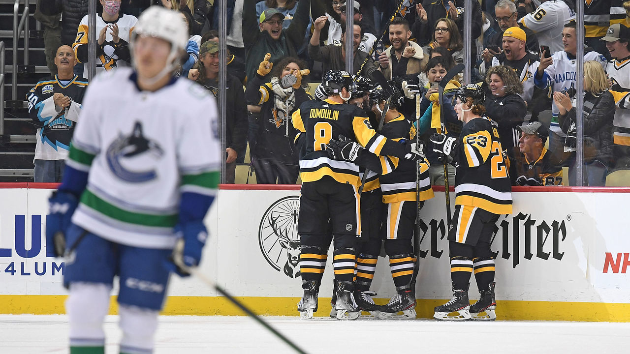 PITTSBURGH, PA - NOVEMBER 24: Zach Aston-Reese #12 of the Pittsburgh Penguins celebrates with teammates after scoring a goal in the second period during the game against the Vancouver Canucks at PPG PAINTS Arena on November 24, 2021 in Pittsburgh, Pennsylvania.