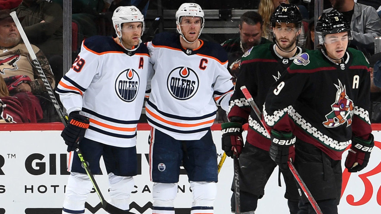 GLENDALE, ARIZONA - NOVEMBER 24: Leon Draisaitl #29 of the Edmonton Oilers celebrates with Connor McDavid #97 after scoring a goal against the Arizona Coyotes during the second period at Gila River Arena on November 24, 2021 in Glendale, Arizona.