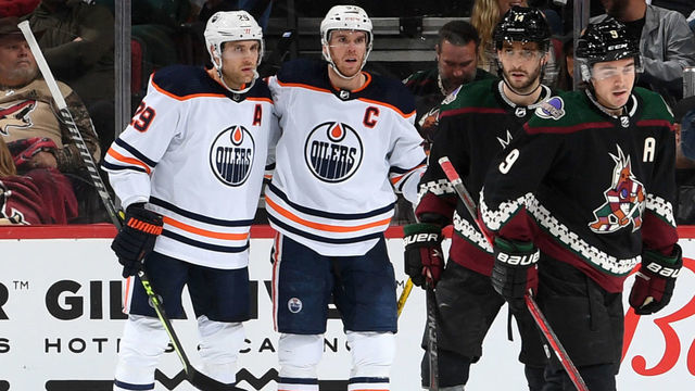 GLENDALE, ARIZONA - NOVEMBER 24: Leon Draisaitl #29 of the Edmonton Oilers celebrates with Connor McDavid #97 after scoring a goal against the Arizona Coyotes during the second period at Gila River Arena on November 24, 2021 in Glendale, Arizona.