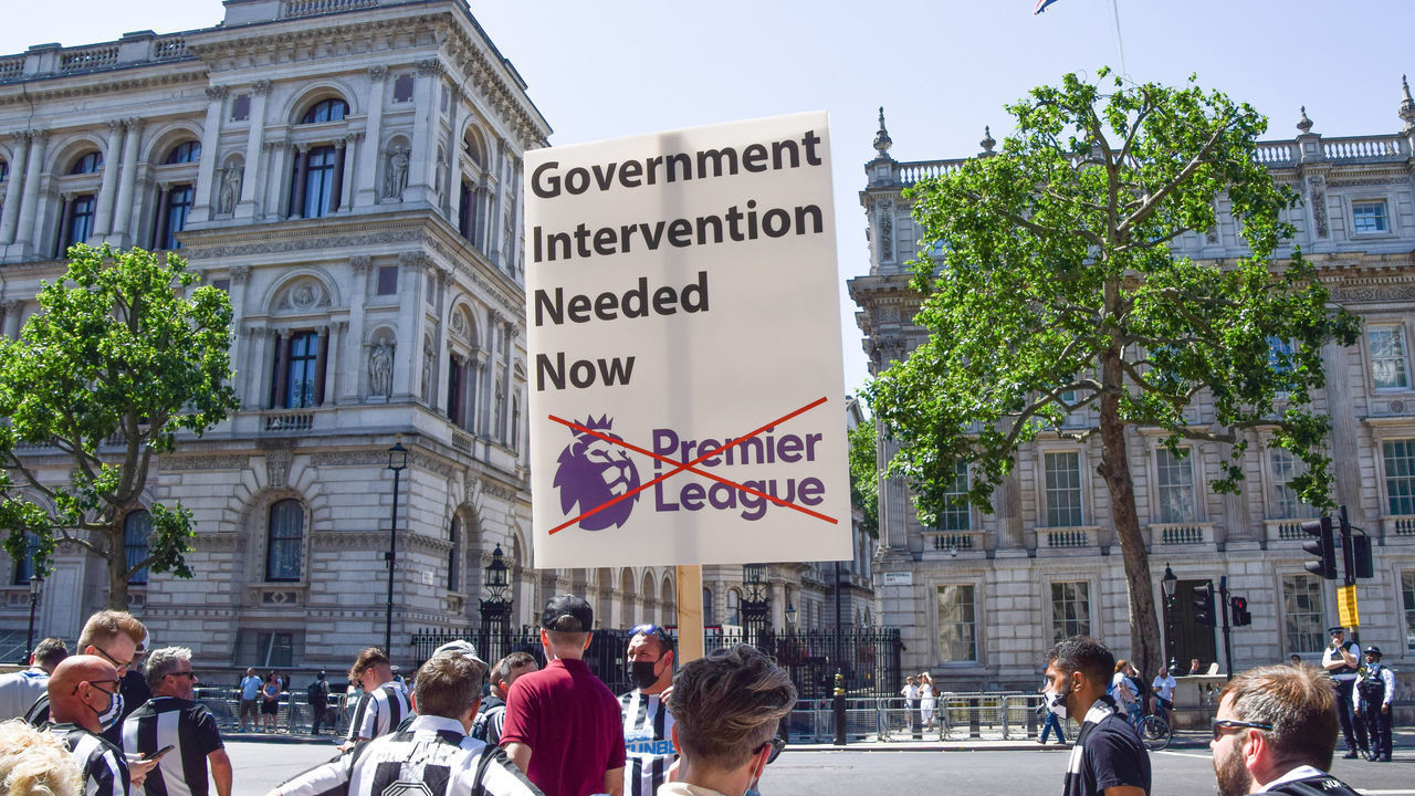 LONDON, UNITED KINGDOM - 2021/07/16: A protester holds a placard saying 'Government Intervention Needed Now' during the demonstration outside Downing Street. Newcastle United Football Club fans gathered in Westminster to demand transparency and public arbitration in the club takeover.