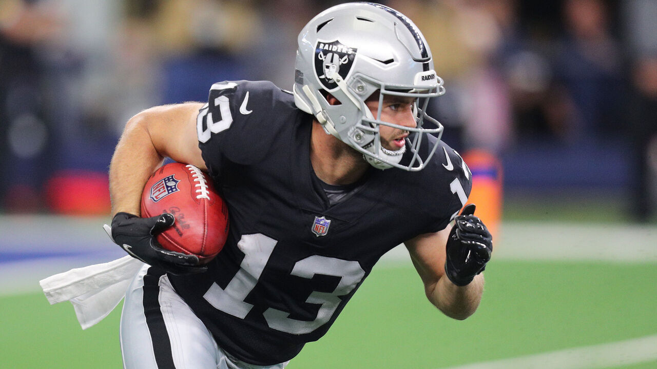 ARLINGTON, TEXAS - NOVEMBER 25: Hunter Renfrow #13 of the Las Vegas Raiders carries the ball after a punt return during the first quarter of the NFL match between Las Vegas Raiders and Dallas Cowboys at AT&T Stadium on November 25, 2021 in Arlington, Texas.