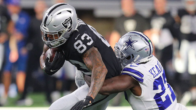 ARLINGTON, TEXAS - NOVEMBER 25: Darren Waller #83 of the Las Vegas Raiders is tackled by Jayron Kearse #27 of the Dallas Cowboys during the second quarter of the NFL match between Las Vegas Raiders and Dallas Cowboys at AT&T Stadium on November 25, 2021 in Arlington, Texas.