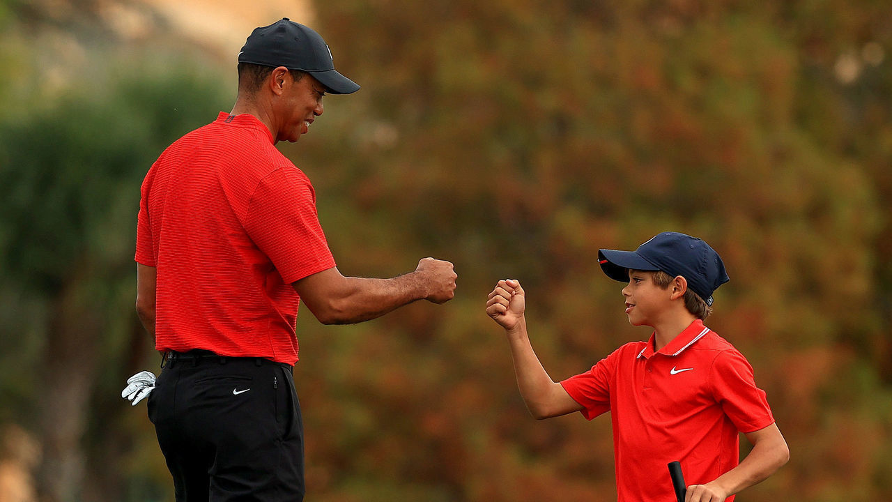 ORLANDO, FLORIDA - DECEMBER 20: Tiger Woods of the United States and son Charlie Woods fist bump on the 18th hole during the final round of the PNC Championship at the Ritz Carlton Golf Club on December 20, 2020 in Orlando, Florida.