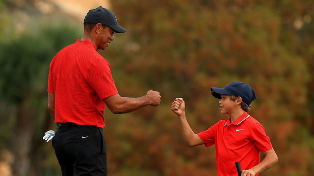 ORLANDO, FLORIDA - DECEMBER 20: Tiger Woods of the United States and son Charlie Woods fist bump on the 18th hole during the final round of the PNC Championship at the Ritz Carlton Golf Club on December 20, 2020 in Orlando, Florida.
