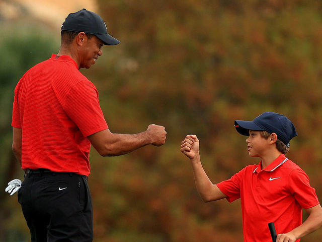 ORLANDO, FLORIDA - DECEMBER 20: Tiger Woods of the United States and son Charlie Woods fist bump on the 18th hole during the final round of the PNC Championship at the Ritz Carlton Golf Club on December 20, 2020 in Orlando, Florida.