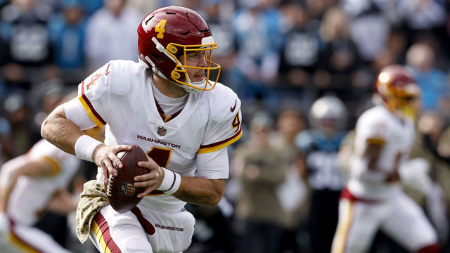 CHARLOTTE, NORTH CAROLINA - NOVEMBER 21: Taylor Heinicke #4 of the Washington Football Team looks to pass against the Carolina Panthers during their game at Bank of America Stadium on November 21, 2021 in Charlotte, North Carolina.