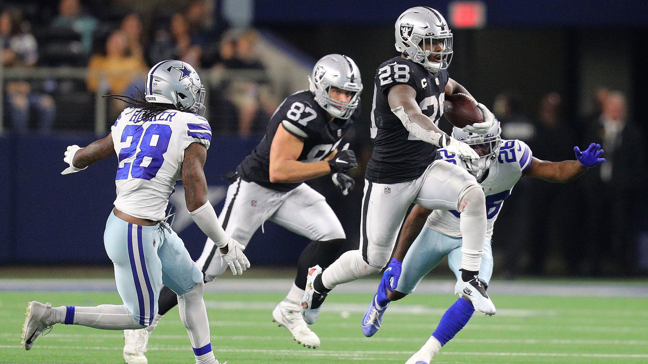 ARLINGTON, TEXAS - NOVEMBER 25: Josh Jacobs #28 of the Las Vegas Raiders makes a carry during overtime of the NFL game between Las Vegas Raiders and Dallas Cowboys at AT&T Stadium on November 25, 2021 in Arlington, Texas.