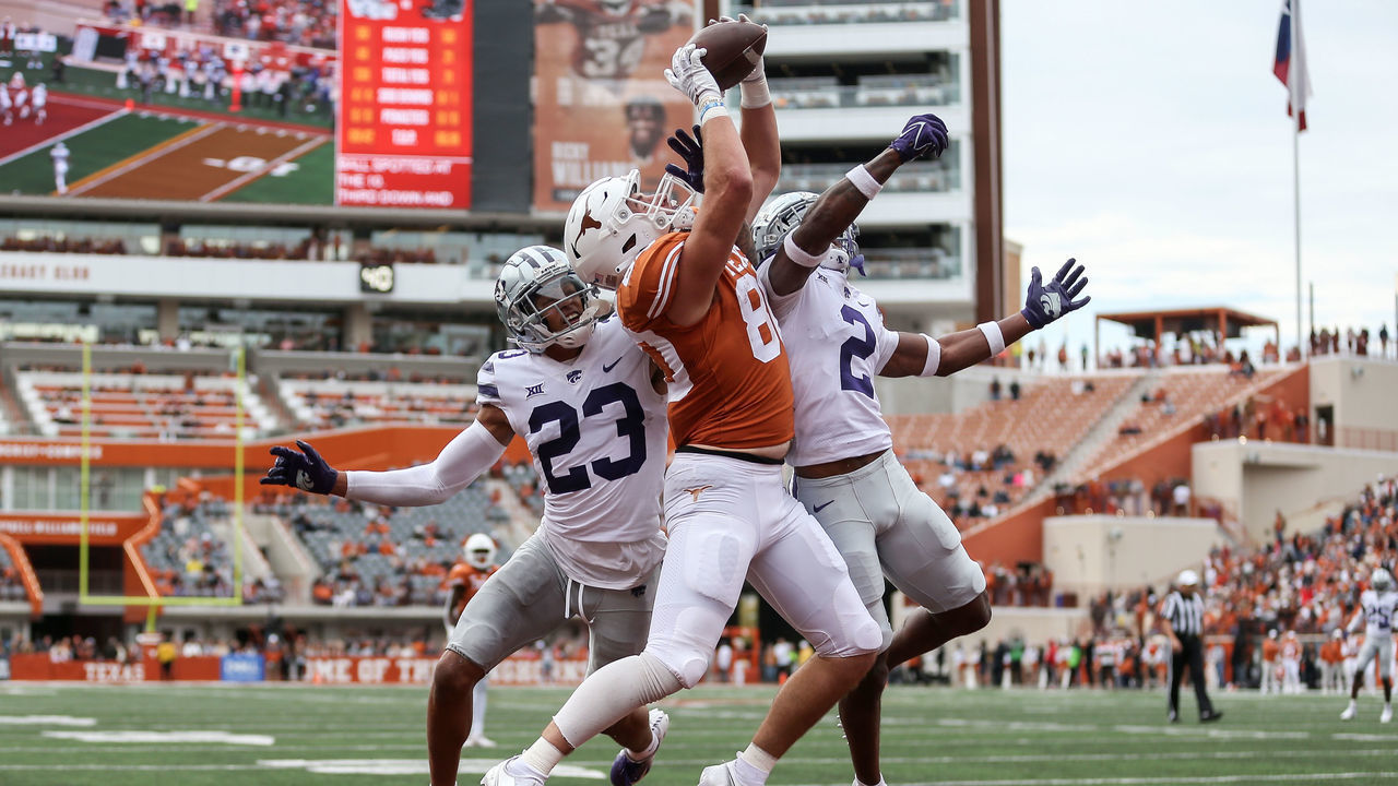 AUSTIN, TEXAS - NOVEMBER 26: Cade Brewer #80 of the Texas Longhorns catches a pass for a touchdown while defended by Julius Brents #23 of the Kansas State Wildcats and Russ Yeast #2 in the second quarter at Darrell K Royal-Texas Memorial Stadium on November 26, 2021 in Austin, Texas.