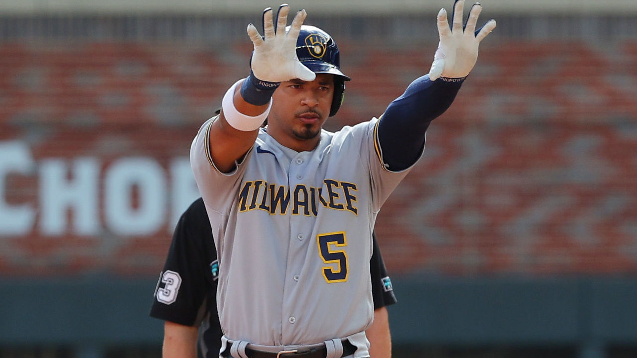 ATLANTA, GEORGIA - OCTOBER 11: Eduardo Escobar #5 of the Milwaukee Brewers doubles during the seventh inning against the Atlanta Braves in game 3 of the National League Division Series at Truist Park on October 11, 2021 in Atlanta, Georgia.