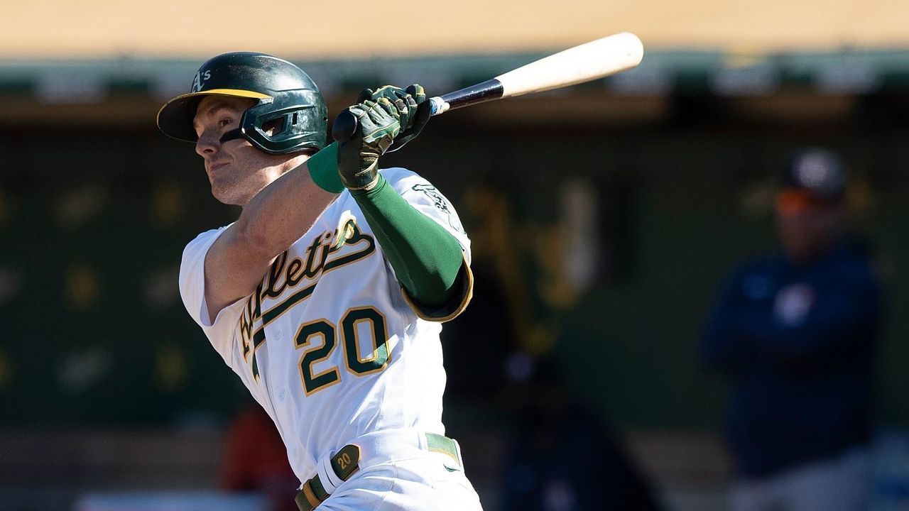 OAKLAND, CALIFORNIA - SEPTEMBER 26: Mark Canha #20 of the Oakland Athletics hits an RBI single against the Houston Astros in the seventh inning at RingCentral Coliseum on September 26, 2021 in Oakland, California. The Athletics won 4-3.