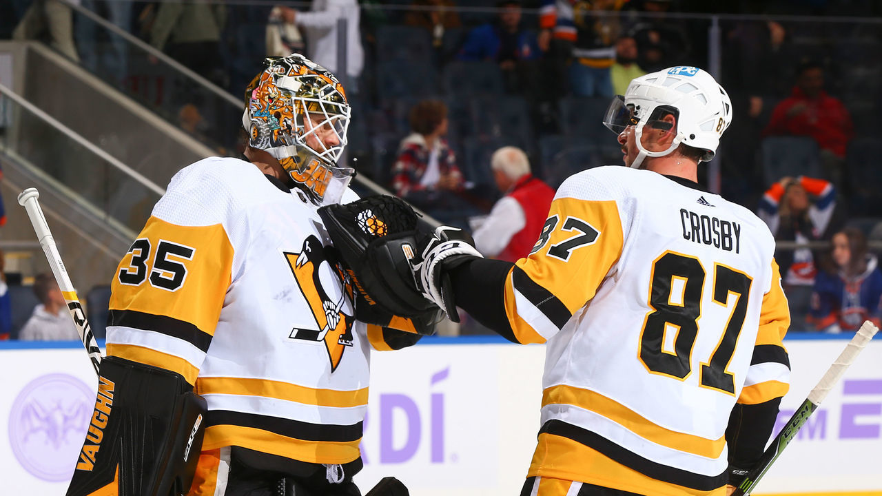 ELMONT, NEW YORK - NOVEMBER 26: Tristan Jarry #35 and Sidney Crosby #87 of the Pittsburgh Penguins celebrate the team's 1-0 win against the New York Islanders at UBS Arena on November 26, 2021 in Elmont, New York.