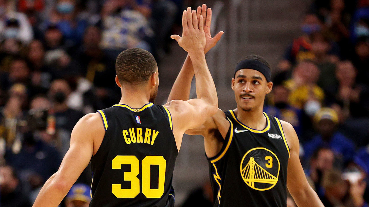SAN FRANCISCO, CALIFORNIA - NOVEMBER 26: Stephen Curry #30 and Jordan Poole #3 of the Golden State Warriors react during the first half of the game against the Portland Trail Blazers at Chase Center on November 26, 2021 in San Francisco, California.