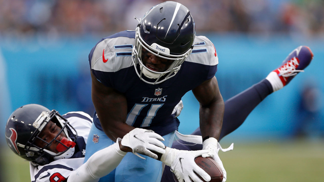 NASHVILLE, TENNESSEE - NOVEMBER 21: A.J. Brown #11 of the Tennessee Titans makes a catch for a first down against Terrance Mitchell #39 of the Houston Texans in the first quarter at Nissan Stadium on November 21, 2021 in Nashville, Tennessee.