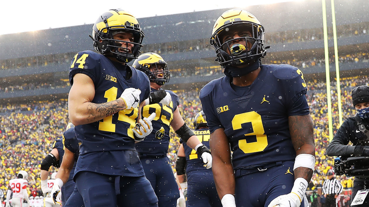 ANN ARBOR, MICHIGAN - NOVEMBER 27: A.J. Henning #3 of the Michigan Wolverines celebrates with teammates after a touchdown against the Ohio State Buckeyes during the first quarter at Michigan Stadium on November 27, 2021 in Ann Arbor, Michigan.