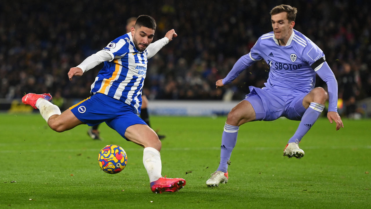 BRIGHTON, ENGLAND - NOVEMBER 27: Neal Maupay of Brighton & Hove Albion shoots whilst under pressure from Diego Llorente of Leeds United during the Premier League match between Brighton & Hove Albion and Leeds United at American Express Community Stadium on November 27, 2021 in Brighton, England.