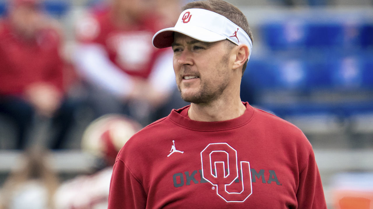 LAWRENCE, KS - OCTOBER 23: Head coach Lincoln Riley of the Oklahoma Sooners talks to players during warmups before taking on the Kansas Jayhawks at David Booth Kansas Memorial Stadium on October 23, 2021 in Lawrence, Kansas.
