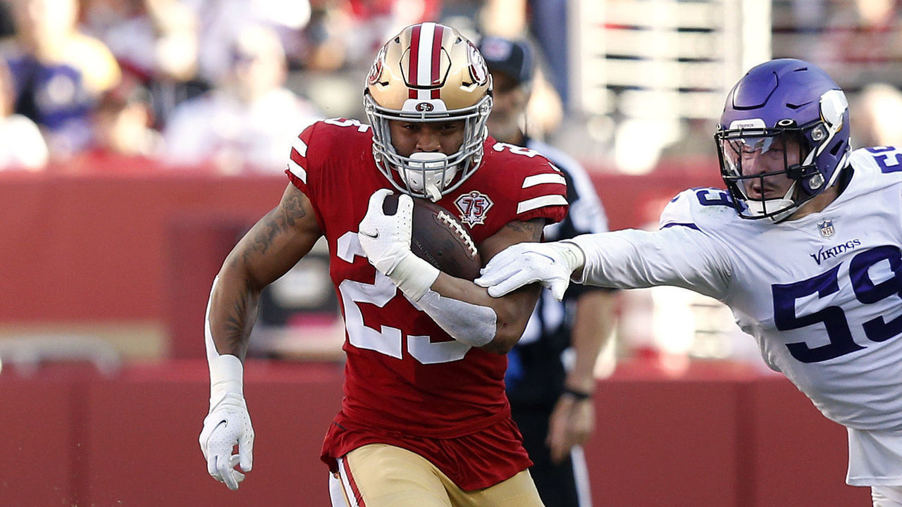 SANTA CLARA, CALIFORNIA - NOVEMBER 28: Elijah Mitchell #25 of the San Francisco 49ers runs for a first down against Nick Vigil #59 of the Minnesota Vikings in the first quarter at Levi's Stadium on November 28, 2021 in Santa Clara, California.