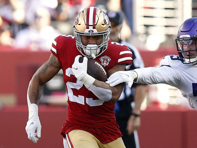 SANTA CLARA, CALIFORNIA - NOVEMBER 28: Elijah Mitchell #25 of the San Francisco 49ers runs for a first down against Nick Vigil #59 of the Minnesota Vikings in the first quarter at Levi's Stadium on November 28, 2021 in Santa Clara, California.