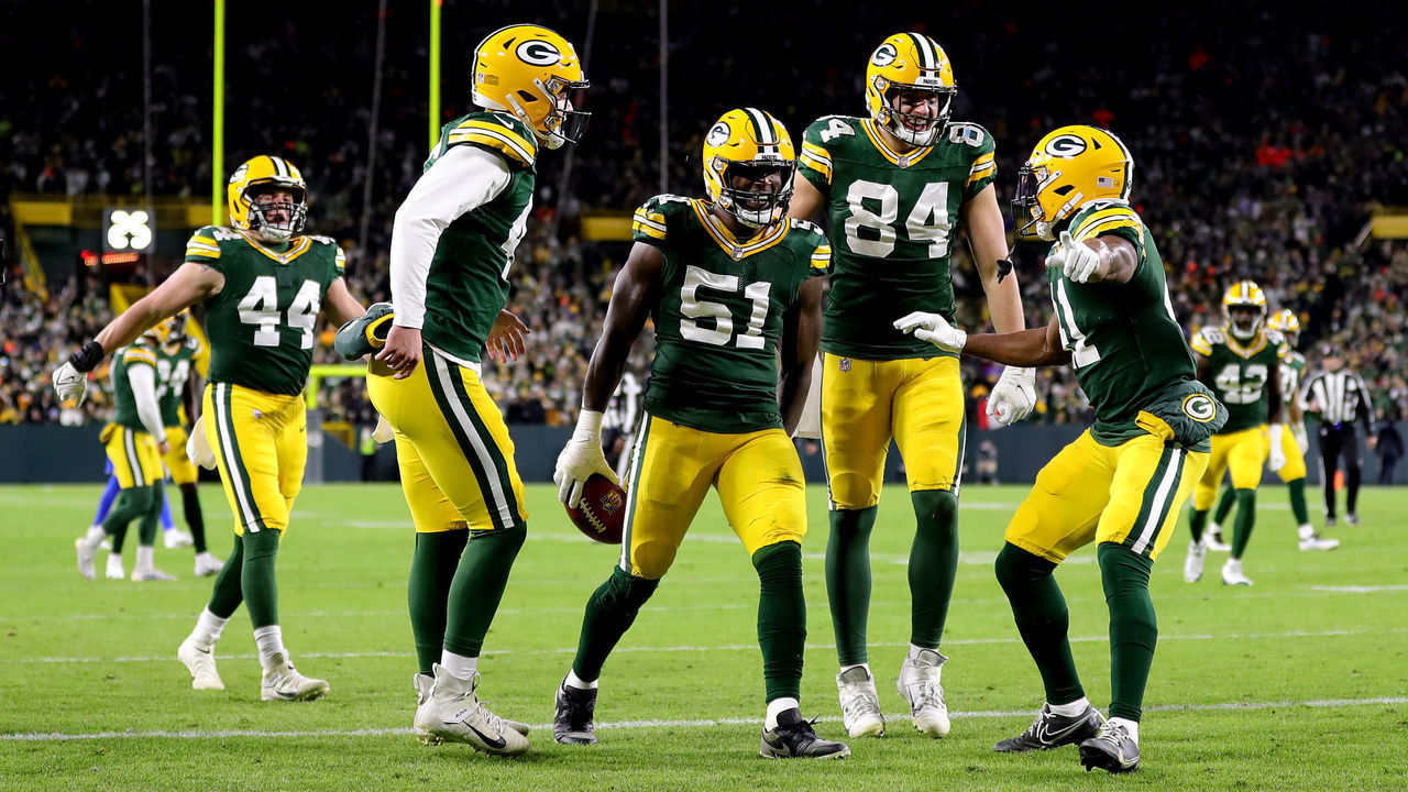 GREEN BAY, WISCONSIN - NOVEMBER 28: Krys Barnes #51 of the Green Bay Packers celebrates with teammates after recovering a fumbled punt catch by J.J. Koski #17 of the Los Angeles Rams (not pictured) during the third quarter at Lambeau Field on November 28, 2021 in Green Bay, Wisconsin.