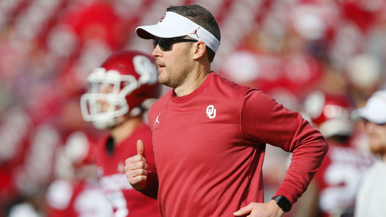 NORMAN, OK - NOVEMBER 20: Head coach Lincoln Riley of the Oklahoma Sooners runs with quarterback Spencer Rattler #7 before a game against the Iowa State Cyclones at Gaylord Family Oklahoma Memorial Stadium on November 20, 2021 in Norman, Oklahoma. The Sooners won 28-21.