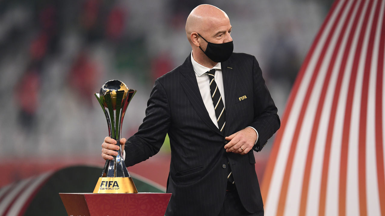 DOHA, QATAR - FEBRUARY 11: Gianni Infantino, President of FIFA picks up the FIFA Club World Cup Qatar 2020 trophy during the presentation ceremony after the FIFA Club World Cup Qatar 2020 Final between FC Bayern Muenchen and Tigres UANL at the Education City Stadium on February 11, 2021 in Doha, Qatar.