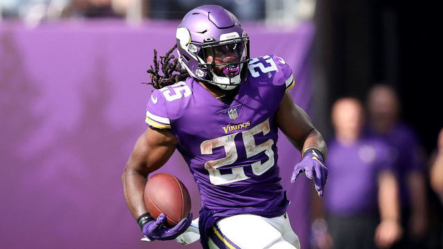 MINNEAPOLIS, MINNESOTA - OCTOBER 10: Alexander Mattison #25 of the Minnesota Vikings carries the ball for a first down as Tracy Walker III #21 of the Detroit Lions is unable to make the stop at U.S. Bank Stadium on October 10, 2021 in Minneapolis, Minnesota. The Minnesota Vikings defeated the Detroit Lions 19-17.
