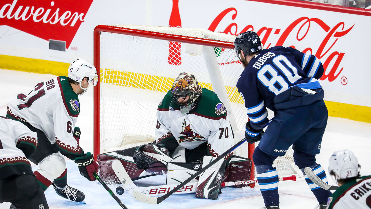 WINNIPEG, MB - NOVEMBER 29: Goaltender Karel Vejmelka #70 of the Arizona Coyotes makes a save on Pierre-Luc Dubois #80 of the Winnipeg Jets during second period action at the Canada Life Centre on November 29, 2021 in Winnipeg, Manitoba, Canada.