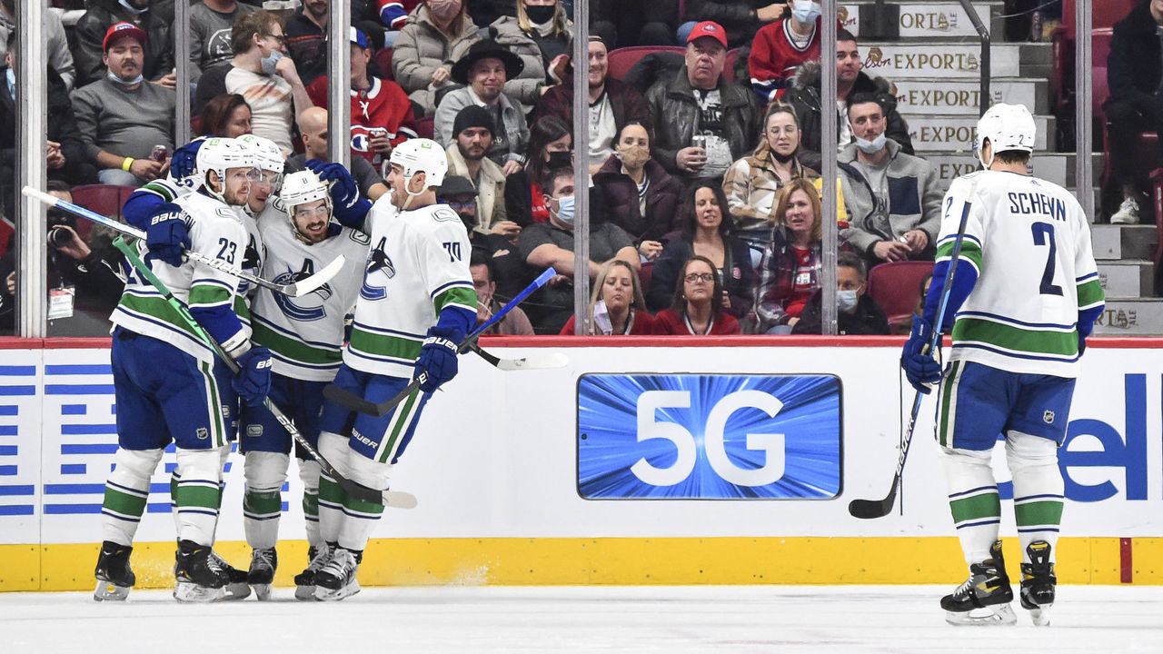 MONTREAL, QC - NOVEMBER 29: Conor Garland #8 of the Vancouver Canucks (C) celebrates his goal with teammates Oliver Ekman-Larsson #23, Bo Horvat #53 and Tanner Pearson #70 during the second period against the Montreal Canadiens at Centre Bell on November 29, 2021 in Montreal, Canada.