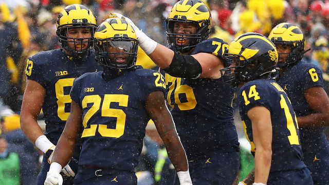 ANN ARBOR, MICHIGAN - NOVEMBER 27: Hassan Haskins #25 of the Michigan Wolverines celebrates with teammates after his touchdown against the Ohio State Buckeyes during the second quarter at Michigan Stadium on November 27, 2021 in Ann Arbor, Michigan.