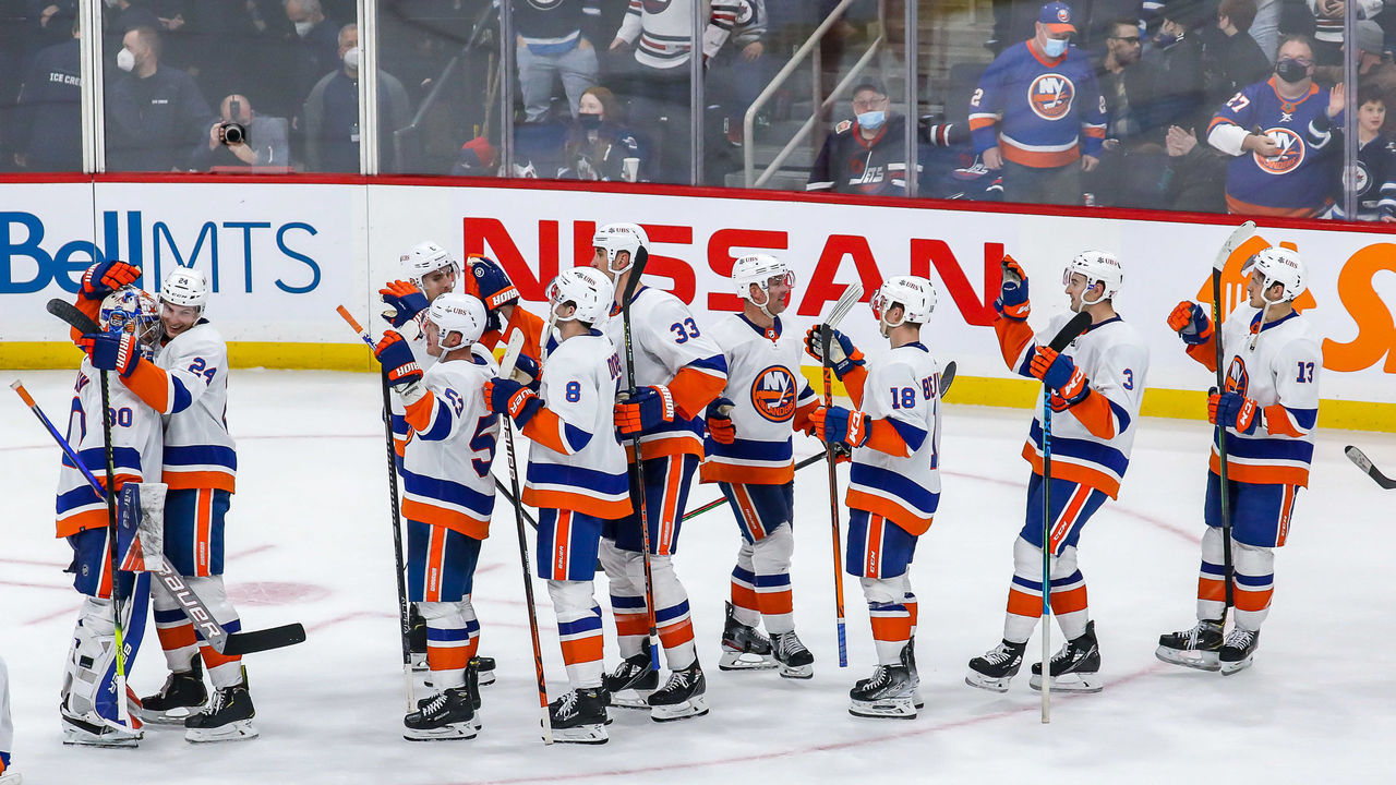 WINNIPEG, MB - NOVEMBER 6: New York Islanders players celebrate on the ice following a 2-0 shutout victory over the Winnipeg Jets at the Canada Life Centre on November 6, 2021 in Winnipeg, Manitoba, Canada.
