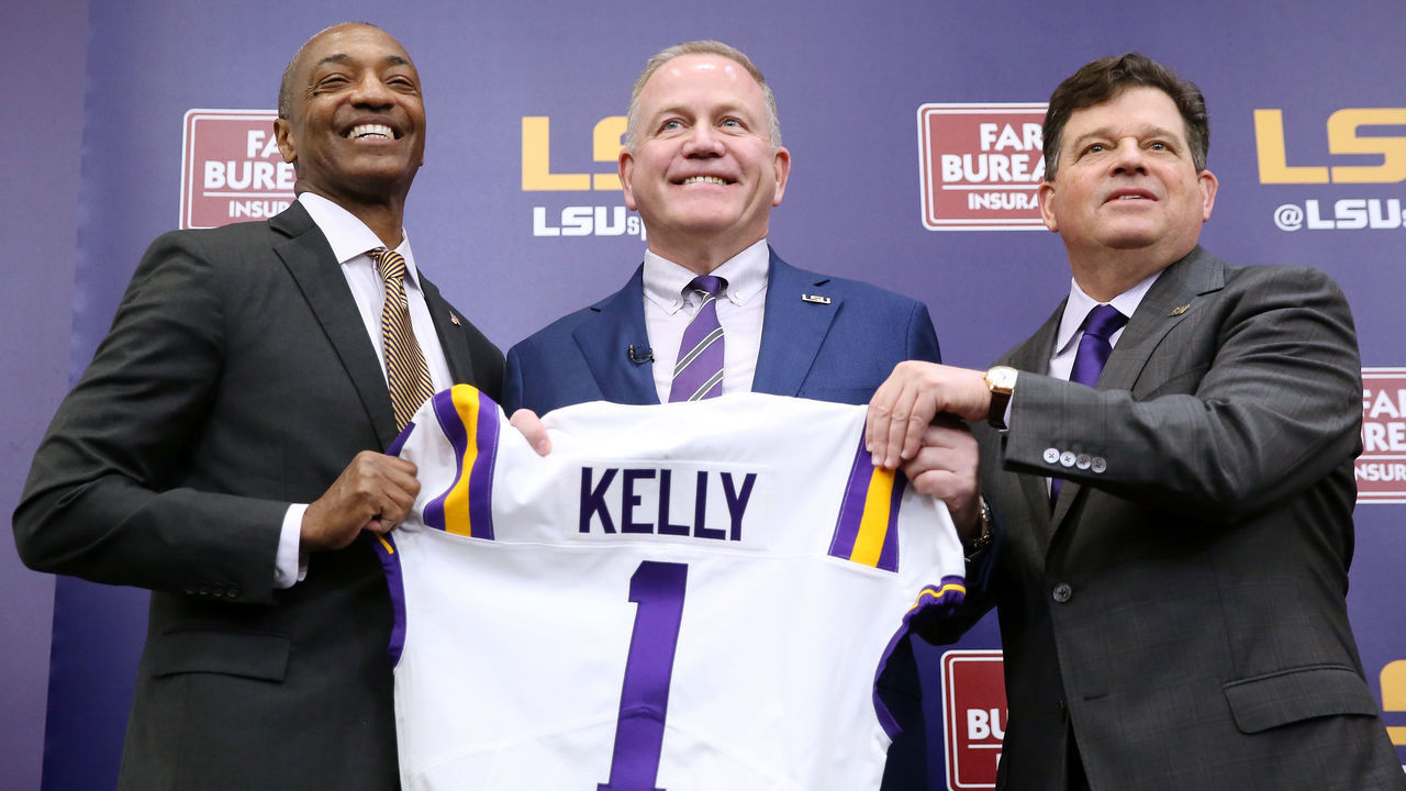 BATON ROUGE, LOUISIANA - DECEMBER 01: Brian Kelly (C) is introduced as the head football coach of the LSU Tigers by LSU President William F. Tate IV (L) and athletics director Scott Woodward during a news conference at Tiger Stadium on December 01, 2021 in Baton Rouge, Louisiana.