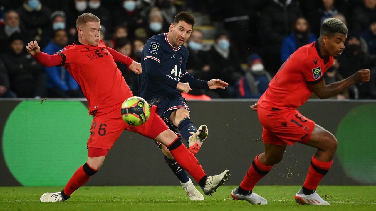 Paris Saint-Germain's Argentinian forward Lionel Messi (C) kicks the ball during the French L1 football match between Paris-Saint Germain (PSG) and OGC Nice at The Parc des Princes Stadium in Paris on December 1, 2021.