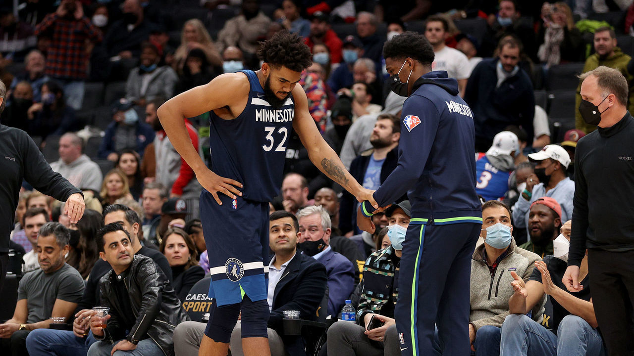 WASHINGTON, DC - DECEMBER 01: Karl-Anthony Towns #32 of the Minnesota Timberwolves is helped off the court after falling and leaving the game in the fourth quarter at Capital One Arena on December 01, 2021 in Washington, DC.
