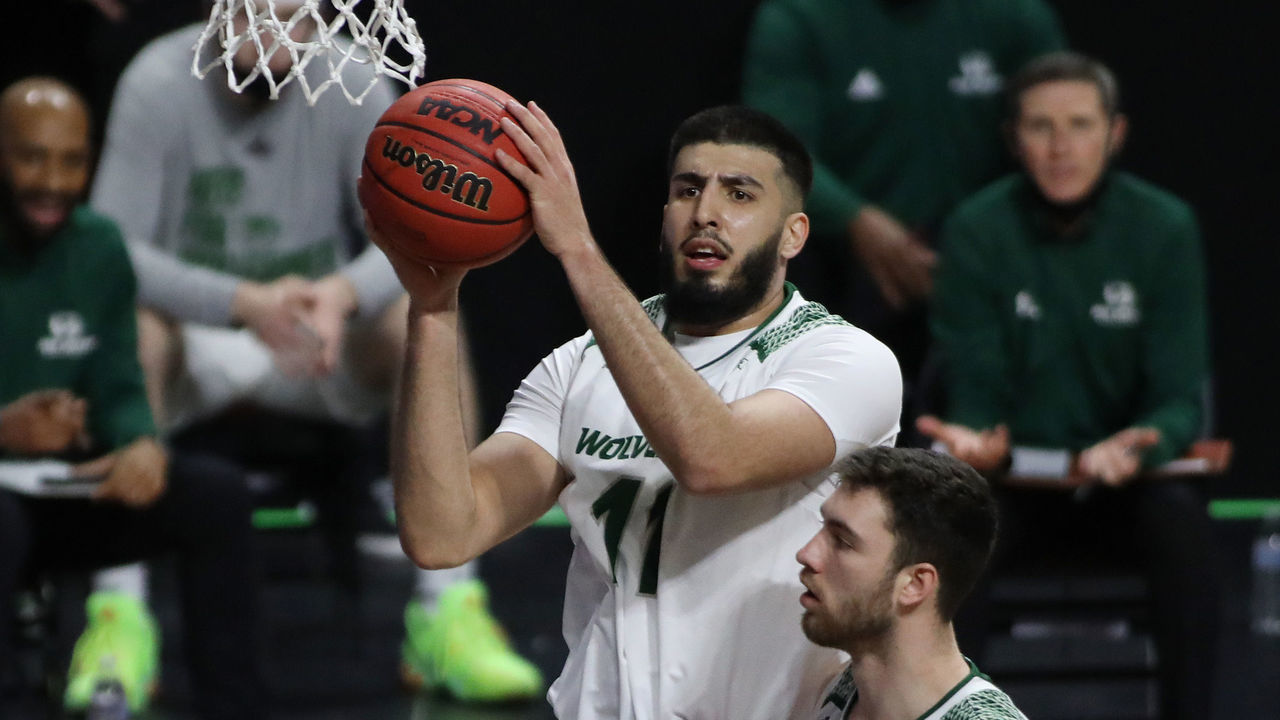 LAS VEGAS, NEVADA - MARCH 12: Fardaws Aimaq #11 of the Utah Valley Wolverines grabs the rebound against the New Mexico State Aggies during a semifinal game of the Western Athletic Conference basketball tournament at the Orleans Arena on March 12, 2021 in Las Vegas, Nevada.