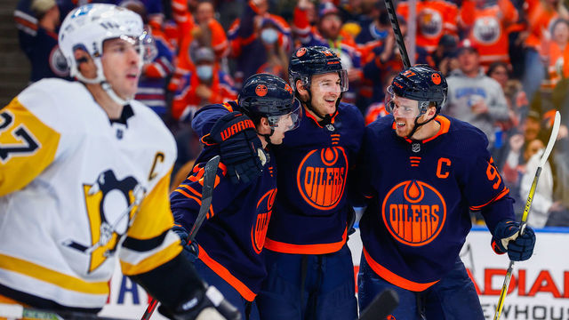 EDMONTON, AB - DECEMBER 1: Edmonton Oilers Center Connor McDavid (97) and Edmonton Oilers Left Wing Zach Hyman (18) celebrate a go ahead goal in front of Pittsburgh Penguins Center Sidney Crosby (87) in the third period during the Edmonton Oilers game versus the Pittsburg Penguins on December 1, 2021 at Rogers Place in Edmonton, AB.