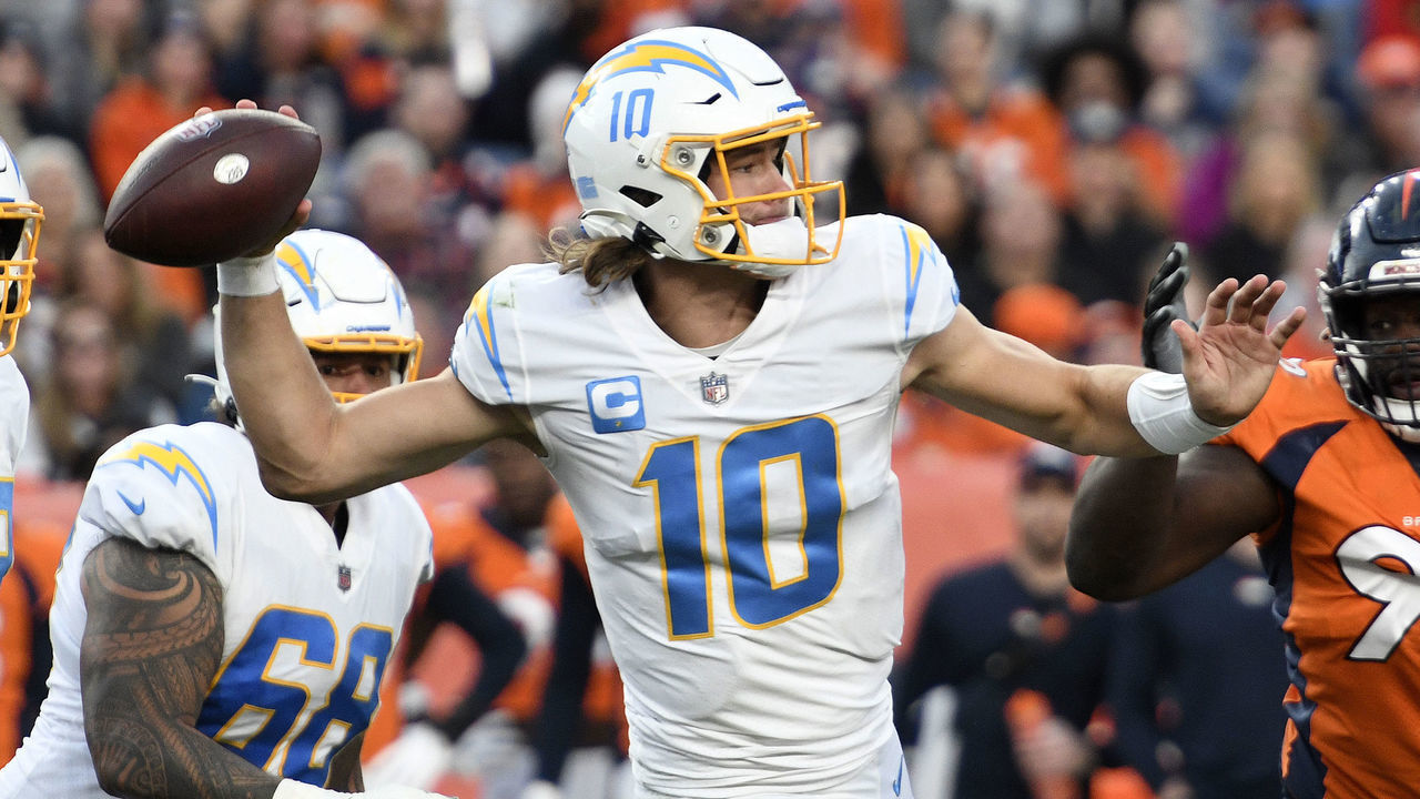DENVER, CO - NOVEMBER 28: Los Angeles Chargers Quarterback Justin Herbert (10) passes as Denver Broncos Defensive End Shamar Stephen (99) defends during the NFL game between the Los Angeles Chargers and the Denver Broncos on November 28, 2021, at Empower Field at Mile High in Denver, Colorado.