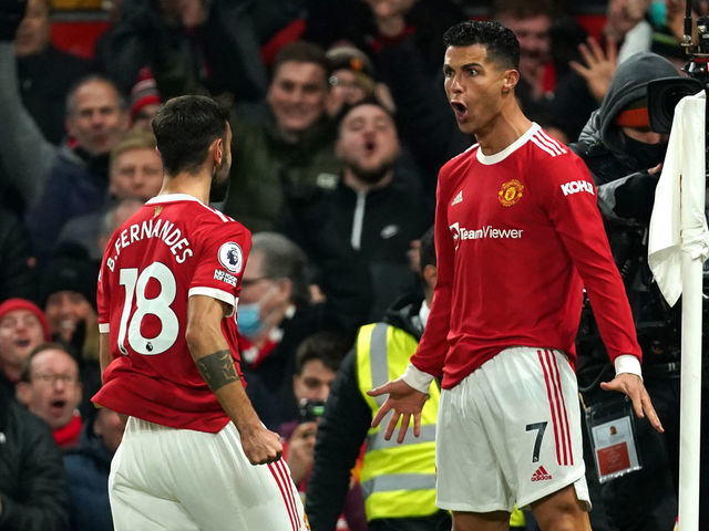 Manchester United's Cristiano Ronaldo (right) celebrates scoring their side's second goal of the game during the Premier League match at Old Trafford, Manchester. Picture date: Thursday December 2, 2021.