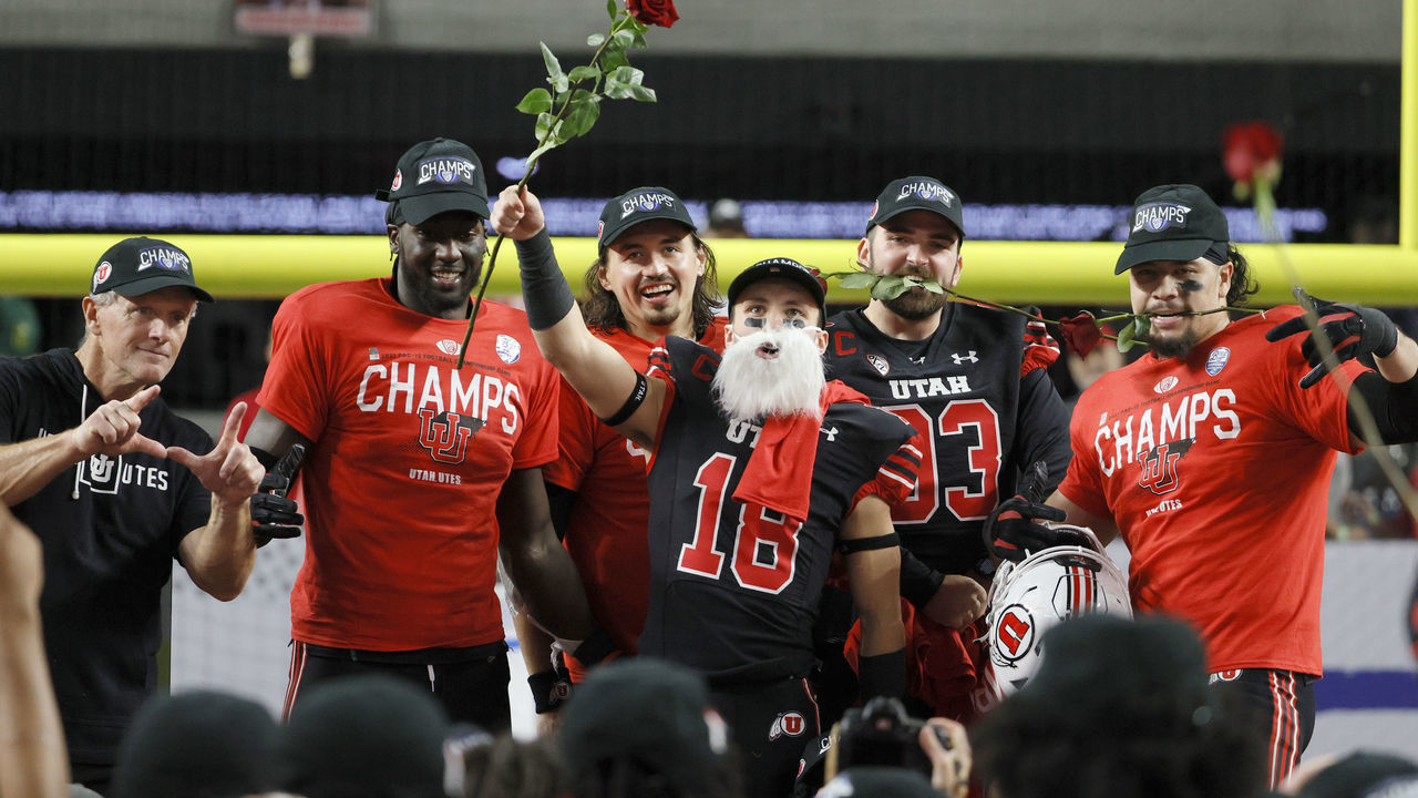 LAS VEGAS, NEVADA - DECEMBER 03: (L-R) Head coach Kyle Whittingham, linebacker Devin Lloyd #0, quarterback Cameron Rising #7, wide receiver Britain Covey #18, long snapper Keegan Markgraf #93 and defensive end Mika Tafua #42 of the Utah Utes celebrate the team's 38-10 victory over the Oregon Ducks to win the Pac-12 Conference championship game at Allegiant Stadium on December 3, 2021 in Las Vegas, Nevada.
