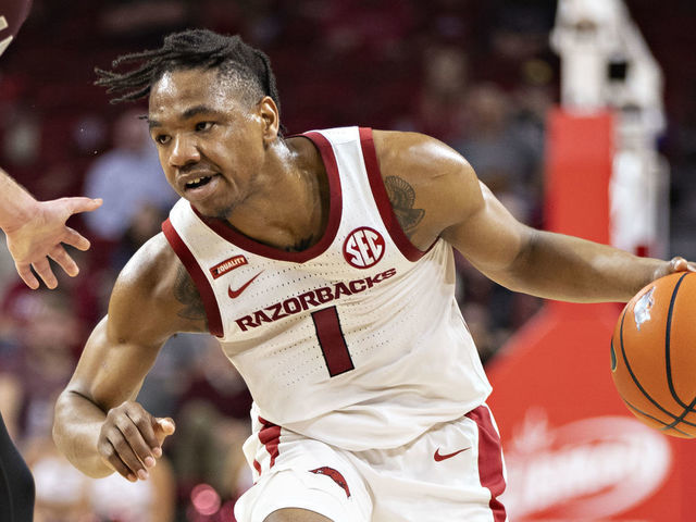 FAYETTEVILLE, ARKANSAS - DECEMBER 04: JD Notae #1 of the Arkansas Razorbacks looks to drive during a game against the Little Rock Trojans at Bud Walton Arena on December 04, 2021 in Fayetteville, Arkansas. The Razorbacks defeated the Trojans 93-78.