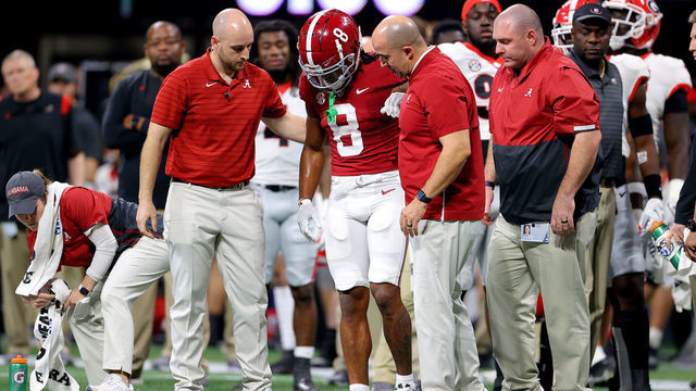 ATLANTA, GEORGIA - DECEMBER 04: John Metchie III #8 of the Alabama Crimson Tide is evaluated for an injury in the second quarter of the SEC Championship game against the Georgia Bulldogs at Mercedes-Benz Stadium on December 04, 2021 in Atlanta, Georgia.
