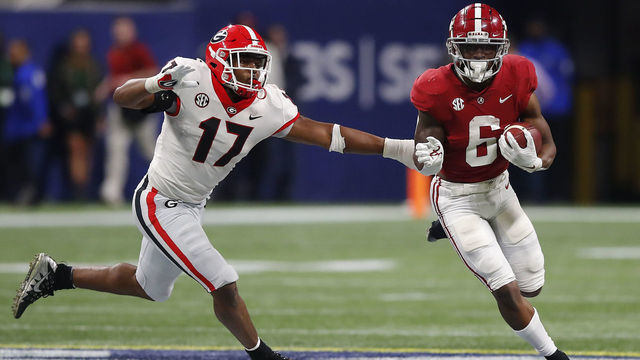 ATLANTA, GEORGIA - DECEMBER 04: Trey Sanders #6 of the Alabama Crimson Tide carries the ball as Nakobe Dean #17 of the Georgia Bulldogs defends during the second half of the SEC Championship game at Mercedes-Benz Stadium on December 04, 2021 in Atlanta, Georgia.